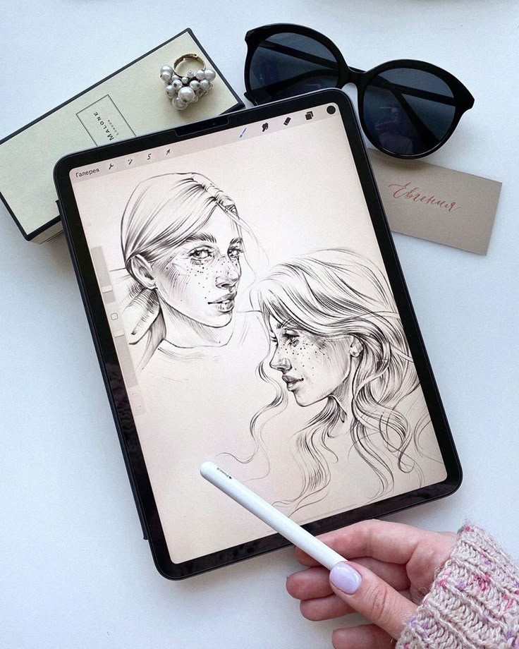 Digital sketch of two women on tablet with stylus, surrounded by sunglasses, book, ring, and card.