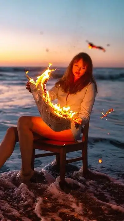 Almost cooked a little too hard there hehe 🗞️🔥 photography photoshoot photoidea Woman reading a burning newspaper while sitting on a chair in the ocean at sunset. | Sky Rye Design Woman reading a burning newspaper while sitting on a chair in the ocean at sunset.
