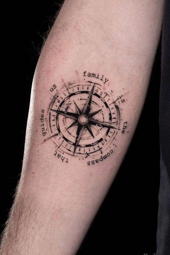 Compass tattoo with family is the compass that guides us text on a forearm, emphasizing direction and family values.