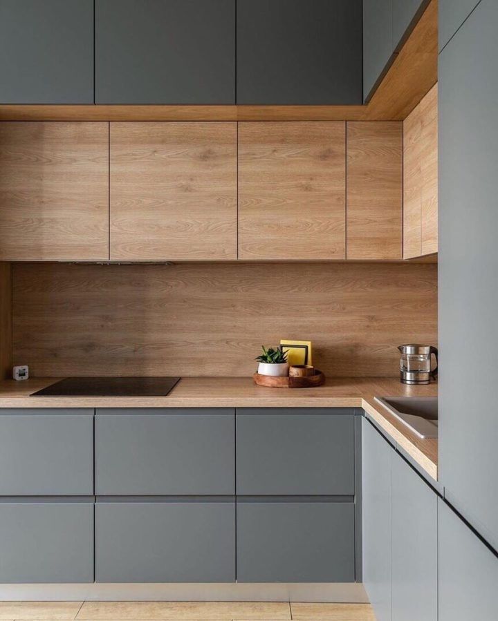 Modern kitchen with sleek gray cabinets and wooden accents, featuring a minimalistic design.