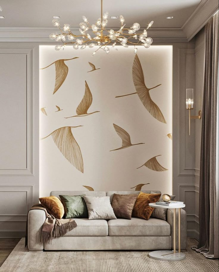 Stylish living room with bird mural, elegant sofa, varied cushions, and modern chandelier. Cozy and contemporary design.