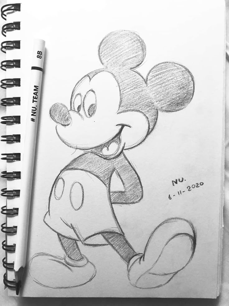 Cartoon character sketch in a notebook with pencil, showcasing a classic animated figure in cheerful pose.