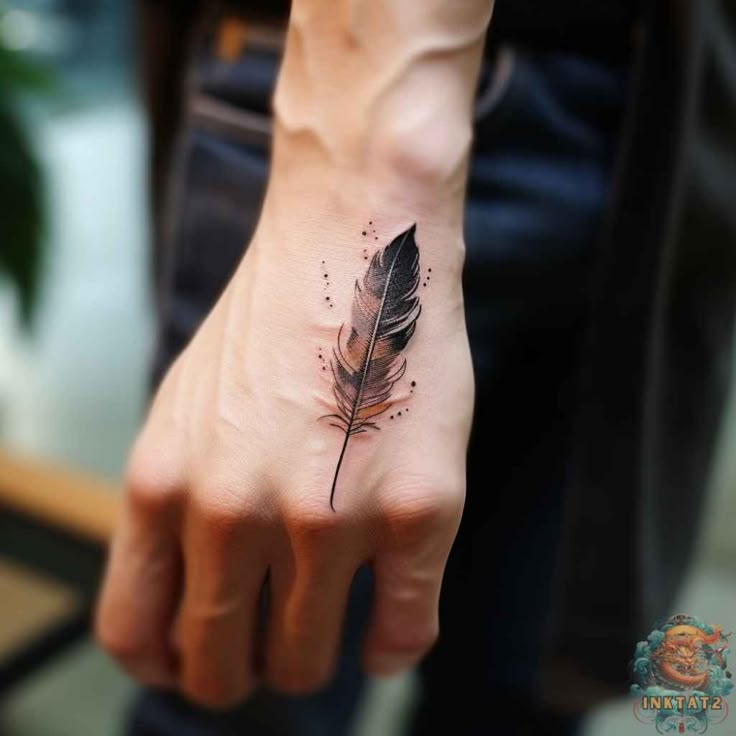 Feather tattoo on hand, detailed black and grey ink design with delicate shading and dots.