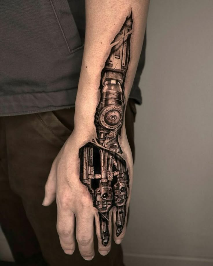 Arm with a realistic biomechanical tattoo design, featuring gears and machinery, creating an illusion of a robotic limb.