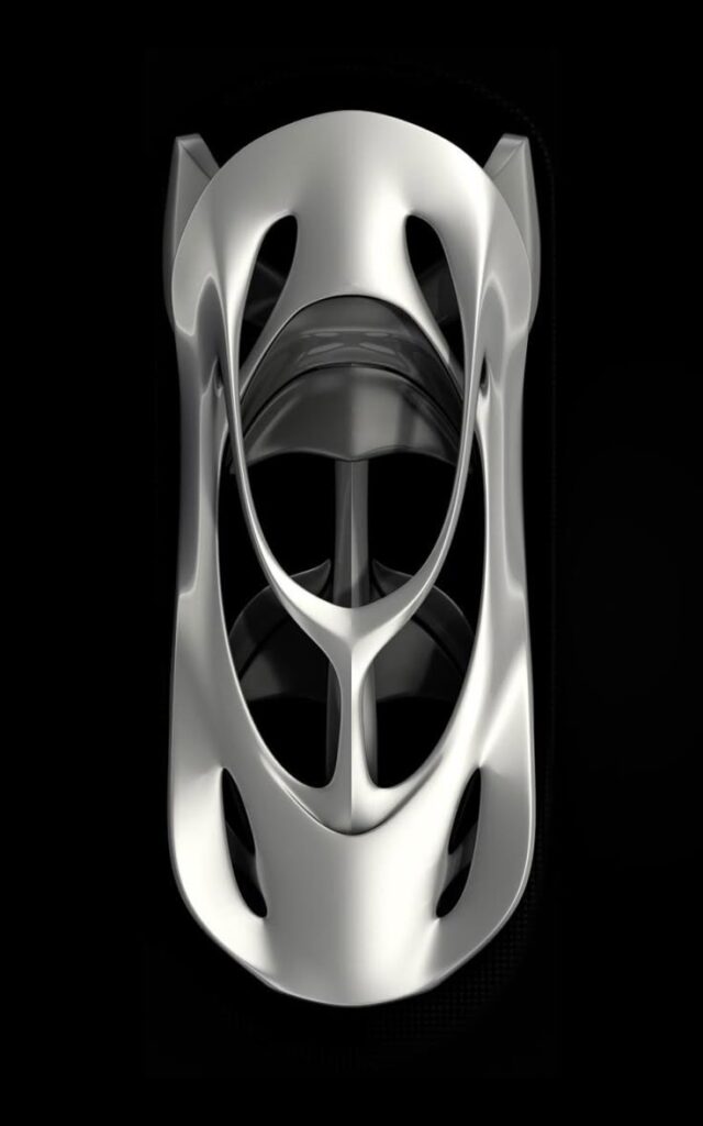 Futuristic silver car concept with aerodynamic design and sleek curves viewed from above.