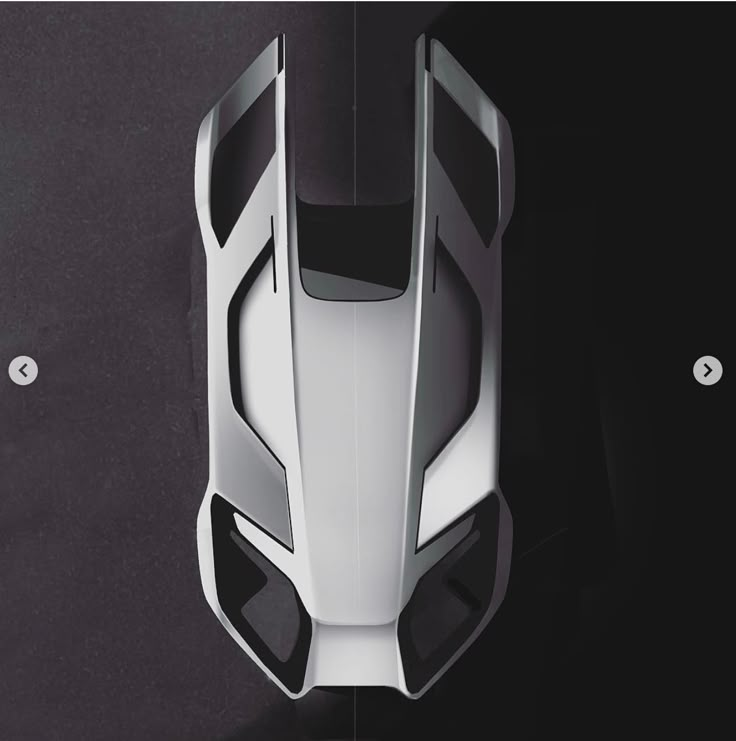 Aerial view of a futuristic, sleek car model design on a dark background, emphasizing sharp lines and aerodynamic form.