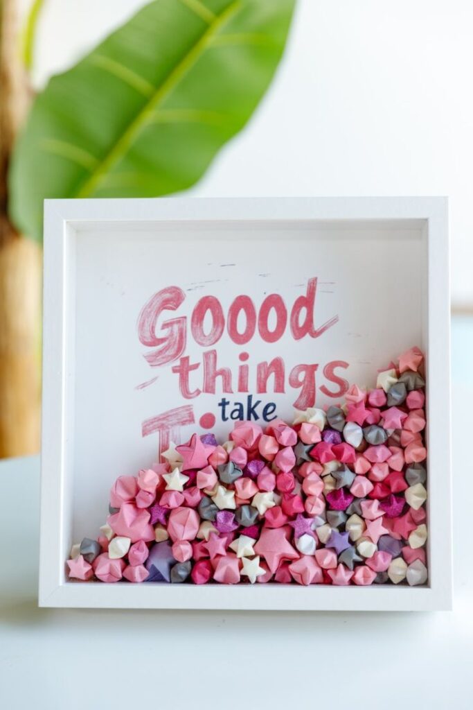 Framed motivational quote Good things take time with colorful paper stars, background with green leaves.