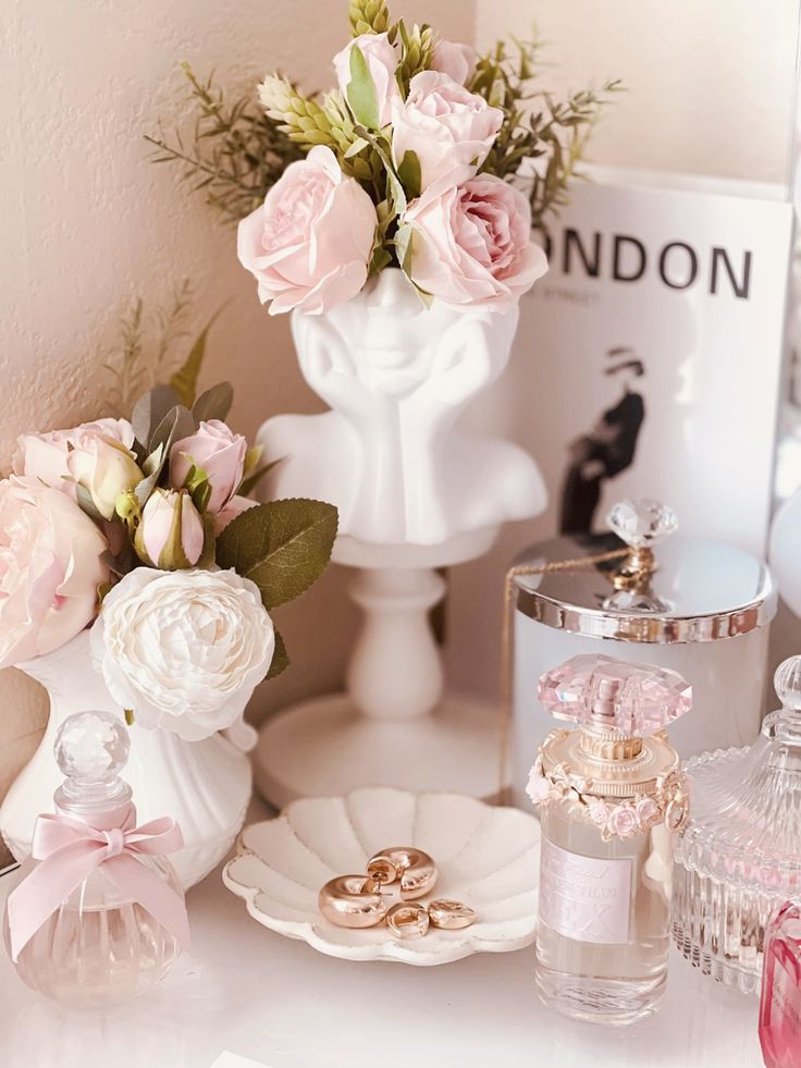 Elegant vanity display with pink roses, perfume bottles, and chic decor for a stylish, feminine touch.