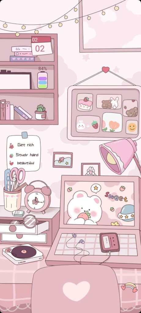 Cute pastel study desk with computer, accessories, and motivational notes in pink aesthetic.