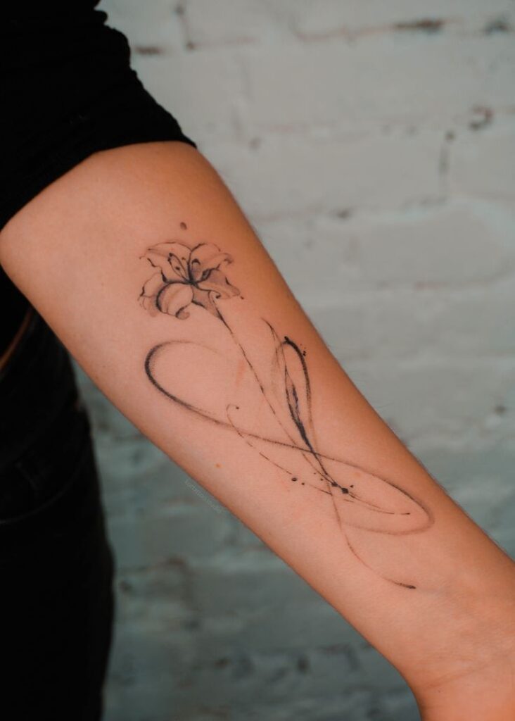 Minimalist floral infinity tattoo on forearm, blending abstract line art and delicate flower design.