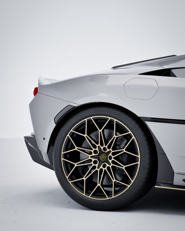 Close-up of a luxury car's rear wheel with gold-accented rim design, Bridgestone tire.