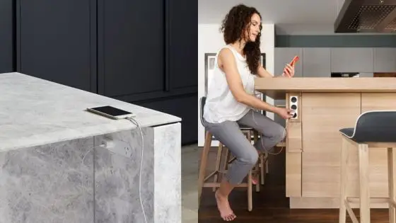 Viewing Deck Blog 8 Woman charging phone at kitchen island with built-in USB ports for convenient and modern tech-friendly design. | Sky Rye Design Woman charging phone at kitchen island with built-in USB ports for convenient and modern tech-friendly design.