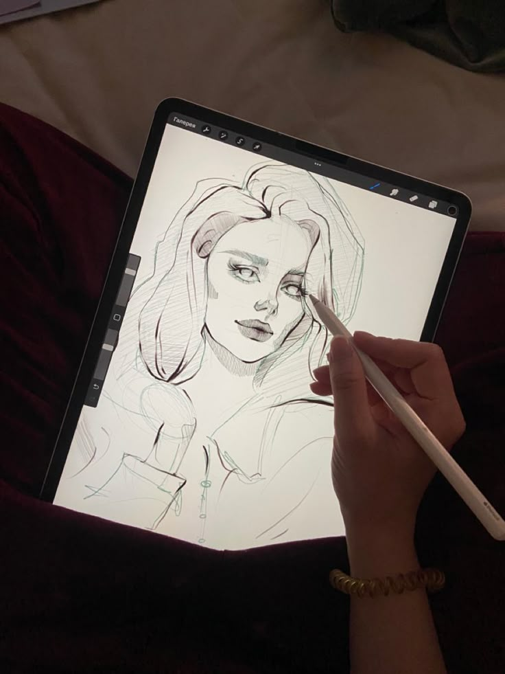 Digital sketching on tablet of a woman's portrait, hand using stylus to draw, creative artwork process.