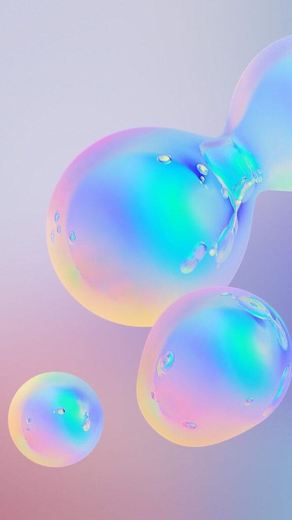 Colorful iridescent bubbles floating against a soft gradient background. Perfect abstract design or wallpaper theme.