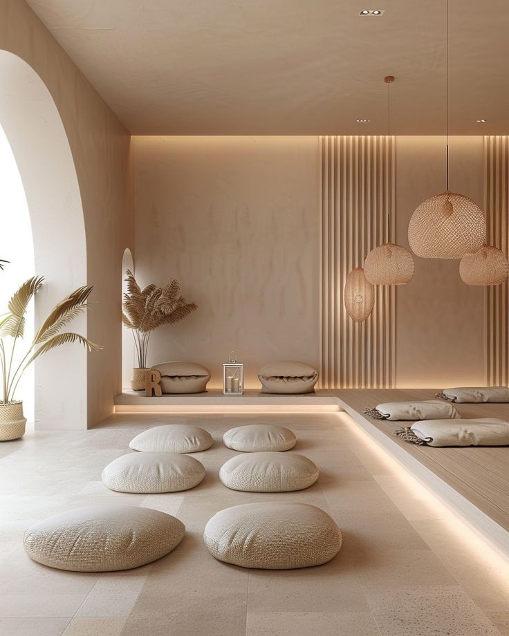 Minimalist meditation room with soft cushions, natural lighting, and wooden accents for a calming ambiance.