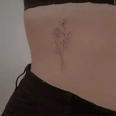 image Minimalist flower tattoo on a person's side torso, featuring delicate blooms and stems, inked in fine lines for an elegant look. | Sky Rye Design Minimalist flower tattoo on a person's side torso, featuring delicate blooms and stems, inked in fine lines for an elegant look.