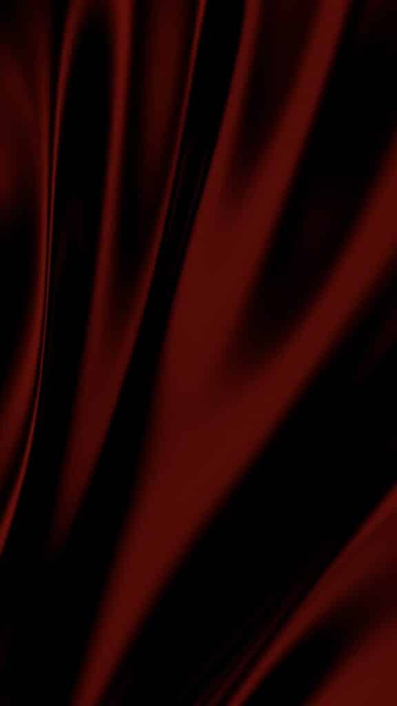Dark red fabric texture with smooth, flowing lines creating an elegant, abstract pattern.