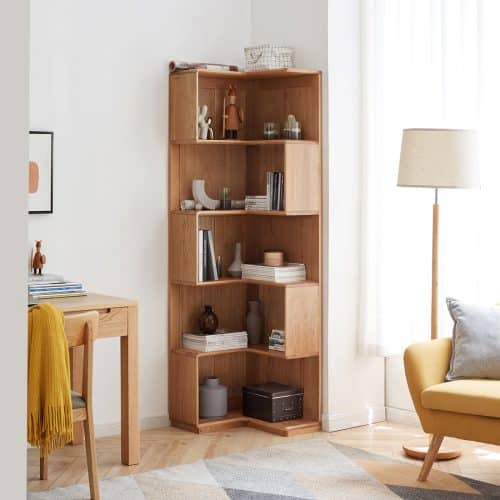 Cozy living room with wooden corner bookshelf, modern decor, and yellow armchair by a window with natural light.