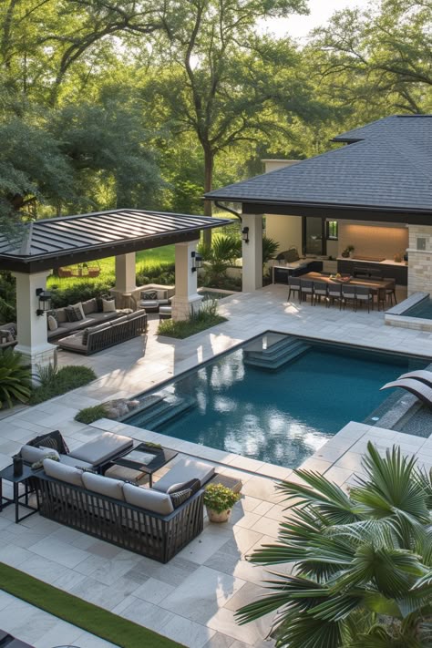 Luxurious backyard with a modern pool, patio seating, and lush trees for a serene outdoor living space ambiance.