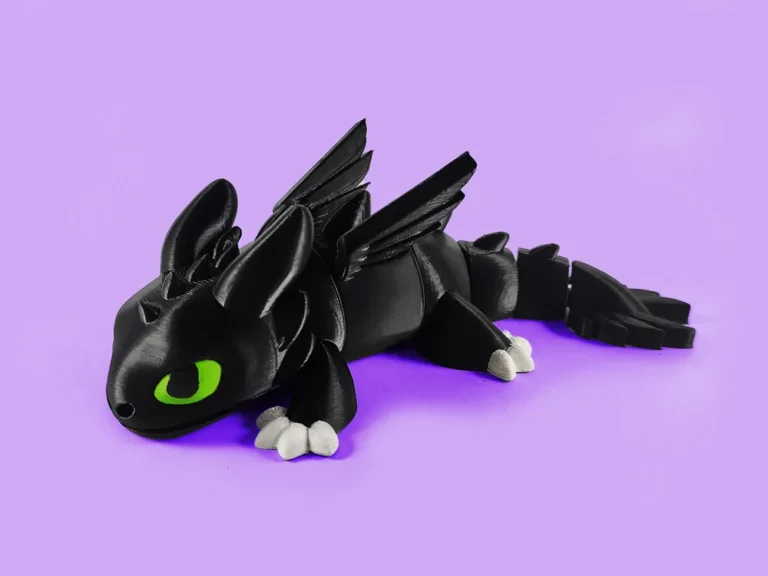 2024-08-14_c67722a1c39b3 Cute black dragon figurine with green eyes on a purple background. | Sky Rye Design Cute black dragon figurine with green eyes on a purple background.
