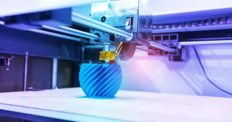 3d-printing-pros-cons 3D printer creating a blue spiral vase object, showcasing modern additive manufacturing technology. | Sky Rye Design 3D printer creating a blue spiral vase object, showcasing modern additive manufacturing technology.