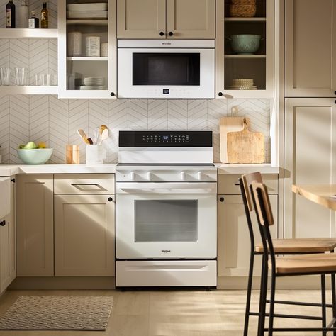 4f9669a1d0724d4b21d4f26b1b2c98a7 Modern kitchen with a sleek stove and microwave, beige cabinets, and stylish decor for a contemporary look. | Sky Rye Design Modern kitchen with a sleek stove and microwave, beige cabinets, and stylish decor for a contemporary look.