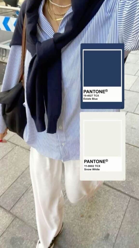 Casual outfit with blue striped shirt, navy sweater, and white pants inspired by Pantone Estate Blue and Snow White.