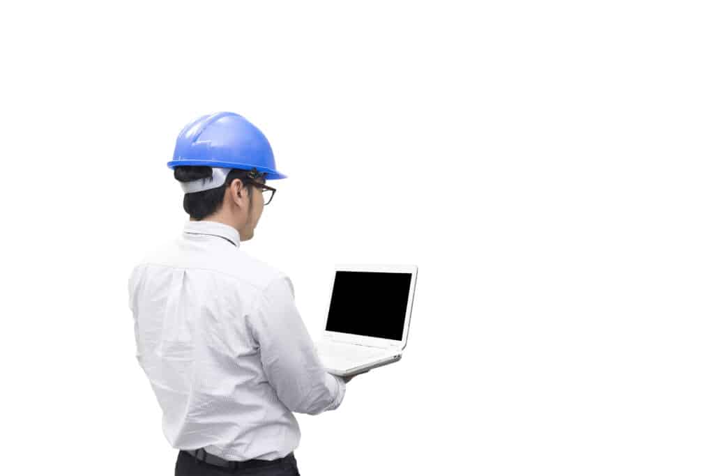Engineer in blue hard hat using laptop on white background.