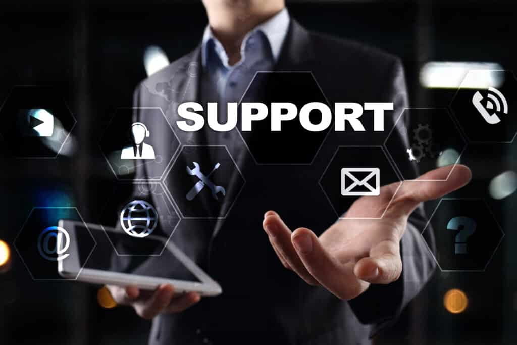 Businessman offers digital support services, concept icons float around tablet, emphasizing communication and assistance.