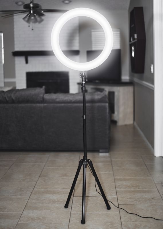 Ring light on a tripod in a living room setting, ideal for photography and video content creation.
