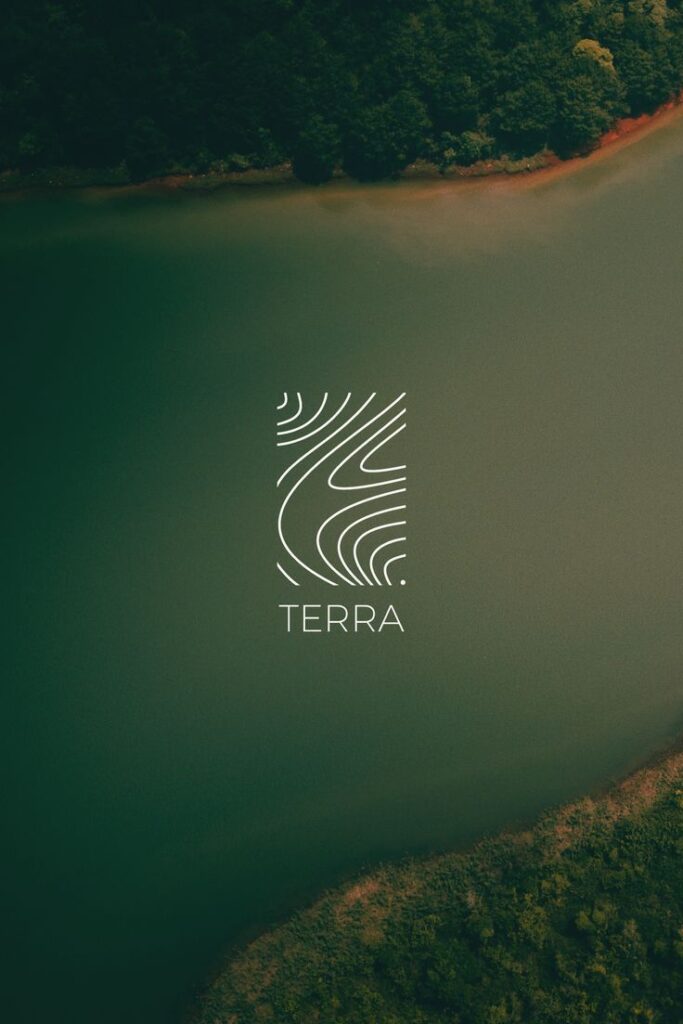 Aerial view of a serene lake with lush forest and the word Terra in stylish font, emphasizing nature's beauty.