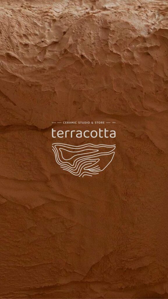 Terracotta ceramic studio logo on textured clay background, est. 1992.