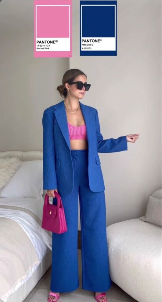 Fashionable woman in blue suit with pink accents, holding a matching handbag. Pantone colors displayed: Sachet Pink, PMS 288 C.
