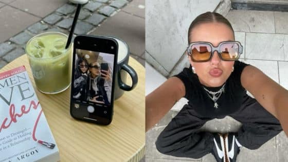 Viewing Deck Blog-11 Woman posing in sunglasses, sitting cross-legged, with a book, iced drink, and phone on a table nearby. | Sky Rye Design Woman posing in sunglasses, sitting cross-legged, with a book, iced drink, and phone on a table nearby.