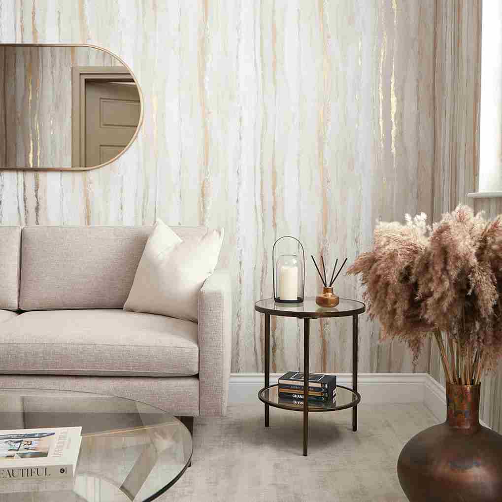 Stylish living room with modern decor, beige sofa, round mirror, and pampas grass arrangement in a vase.