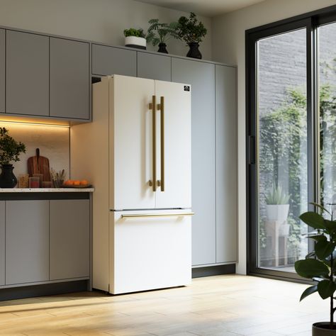 Modern kitchen with sleek white refrigerator and sunlight streaming through large glass doors.