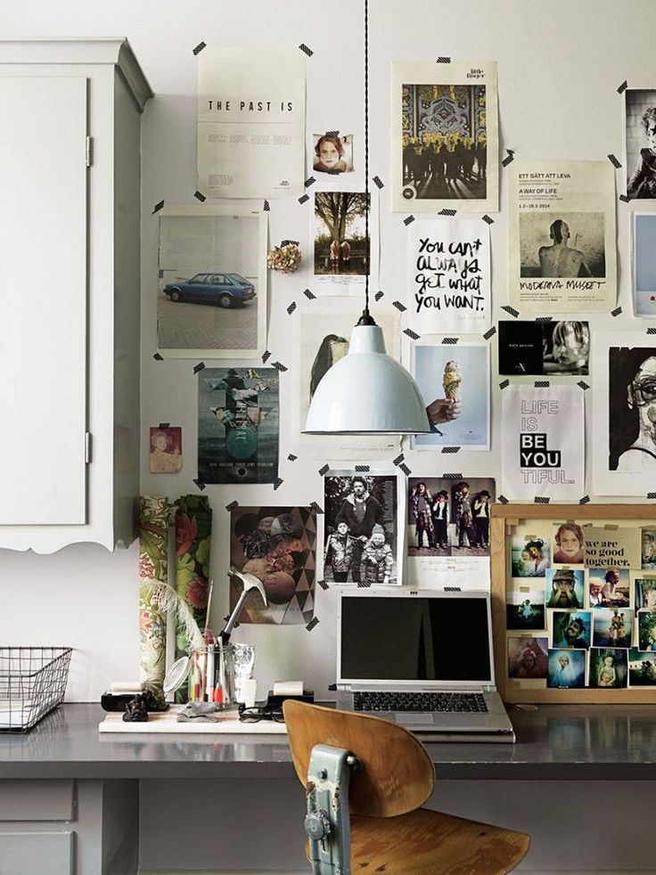 Creative workspace with photo collage, laptop, and industrial lamp, perfect for inspired ideas and productivity.