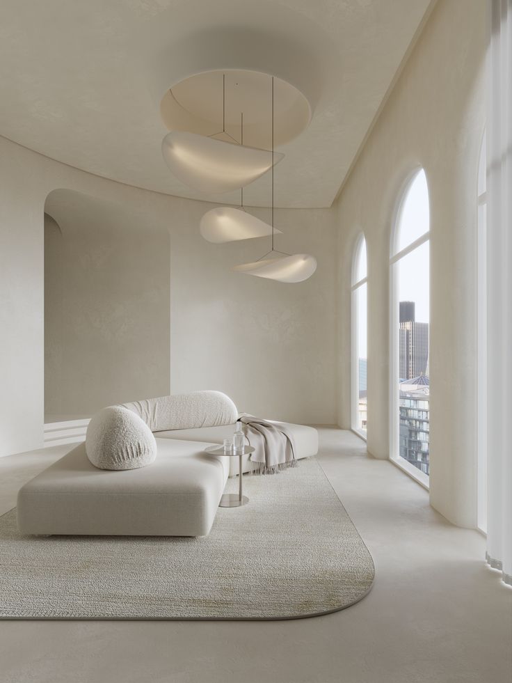 Modern minimalist living room with chic pendant lights, arched windows, and cozy white seating.