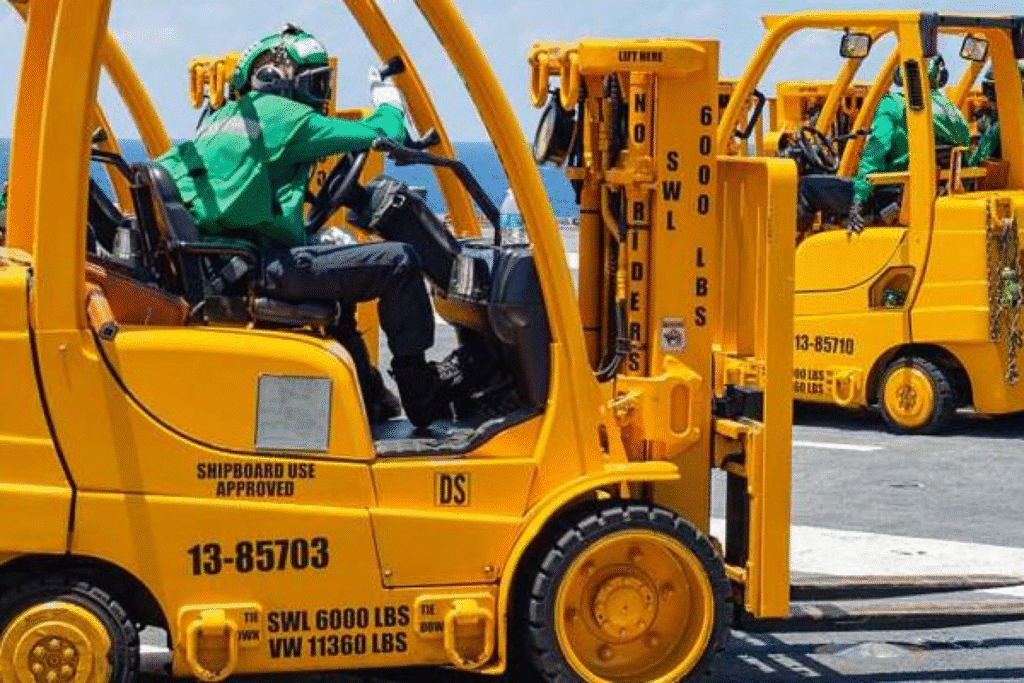 image Workers operating yellow forklifts on a ship deck by the ocean. | Sky Rye Design Workers operating yellow forklifts on a ship deck by the ocean.