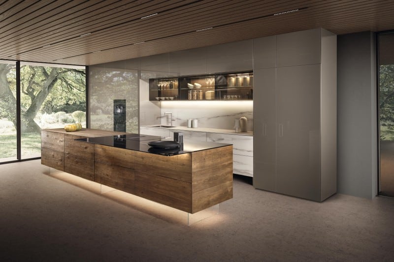 modernkitchenislands1 Modern kitchen interior with wooden island, sleek cabinets, and floor-to-ceiling windows offering a scenic outdoor view. | Sky Rye Design Modern kitchen interior with wooden island, sleek cabinets, and floor-to-ceiling windows offering a scenic outdoor view.