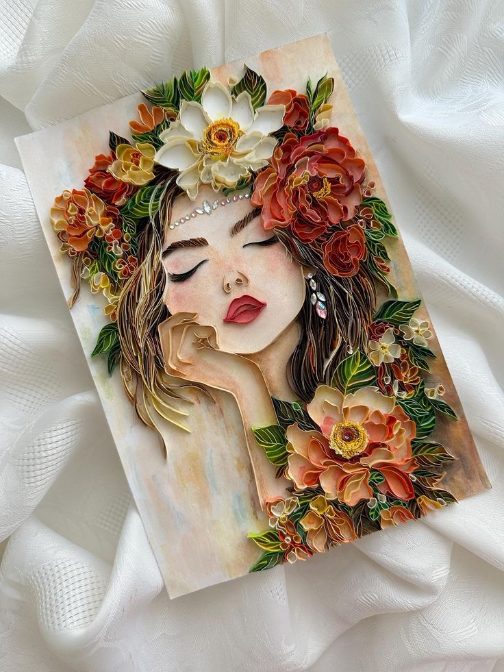 ️Her soul speaks for flowers 🌼 This is an artwork Quilled paper art of a woman's portrait adorned with vibrant flowers and intricate details on a white fabric background. | Sky Rye Design Quilled paper art of a woman's portrait adorned with vibrant flowers and intricate details on a white fabric background.