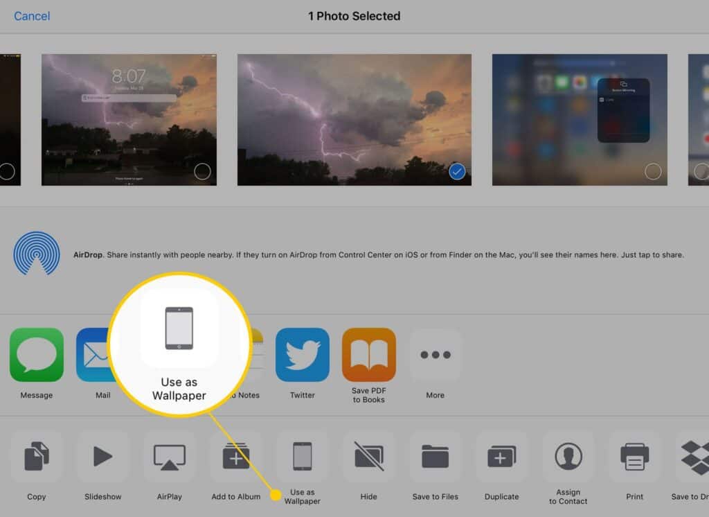 iOS photo app showing options including setting a lightning storm image as wallpaper.