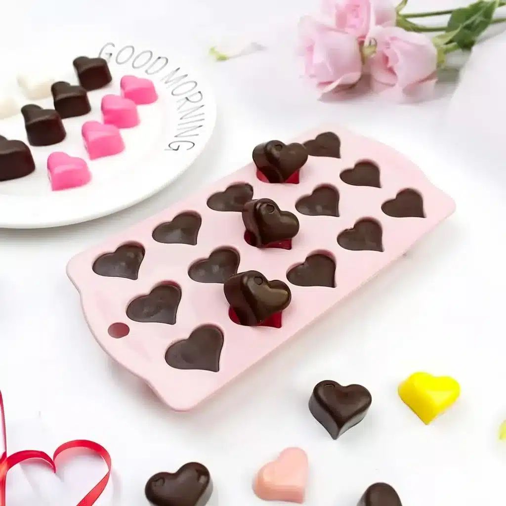 Heart-shaped chocolates in a pink mold with roses and Good Morning plate background. Perfect for a sweet start!