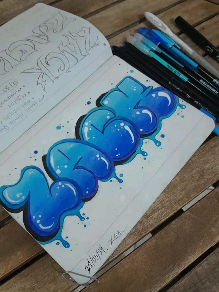 Colorful blue graffiti art in sketchbook with pens on wooden table.
