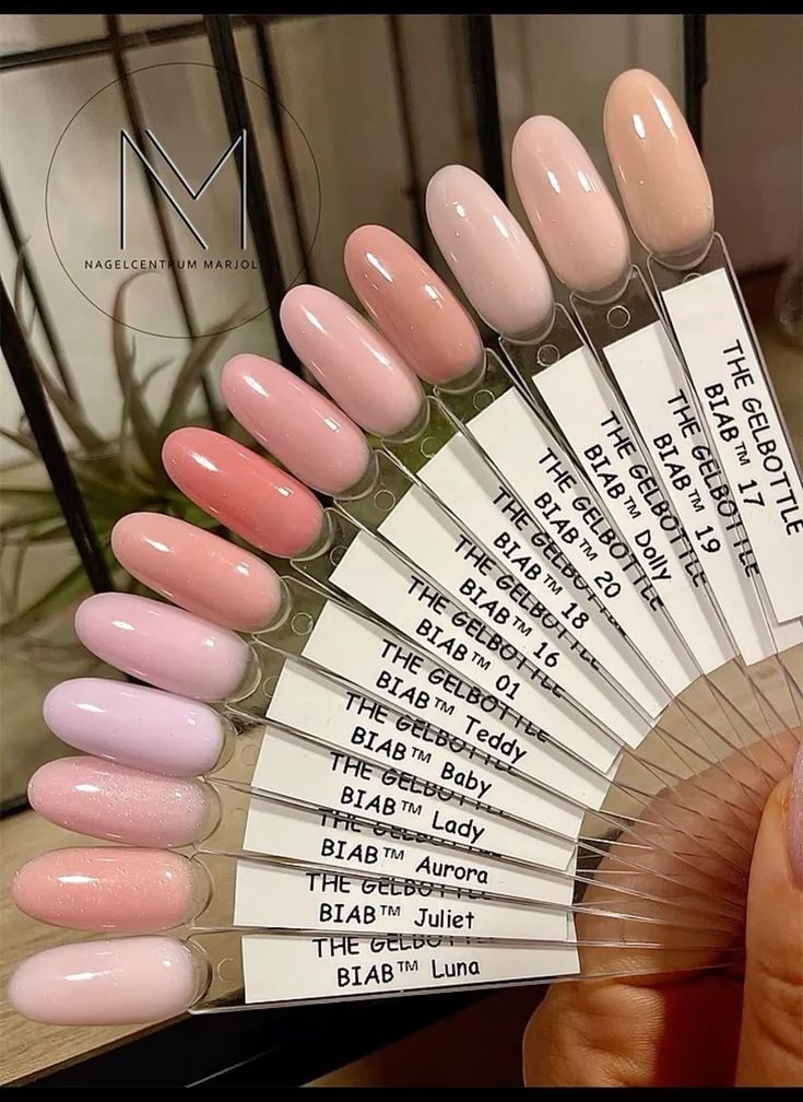 Nude and pink gel nail polish swatches from The GelBottle, displayed on sticks for comparison and selection.
