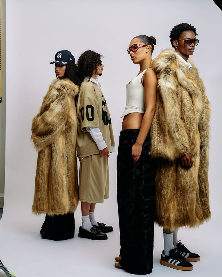 Fashionable group in fur coats and trendy outfits on a white backdrop. Street style chic meets luxury.