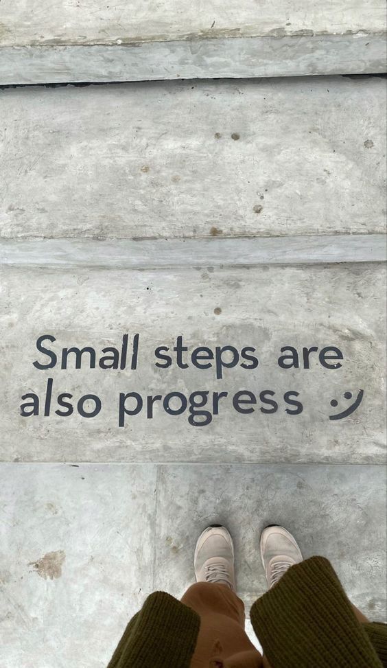 Inspirational quote on stairs: Small steps are also progress with a person standing.