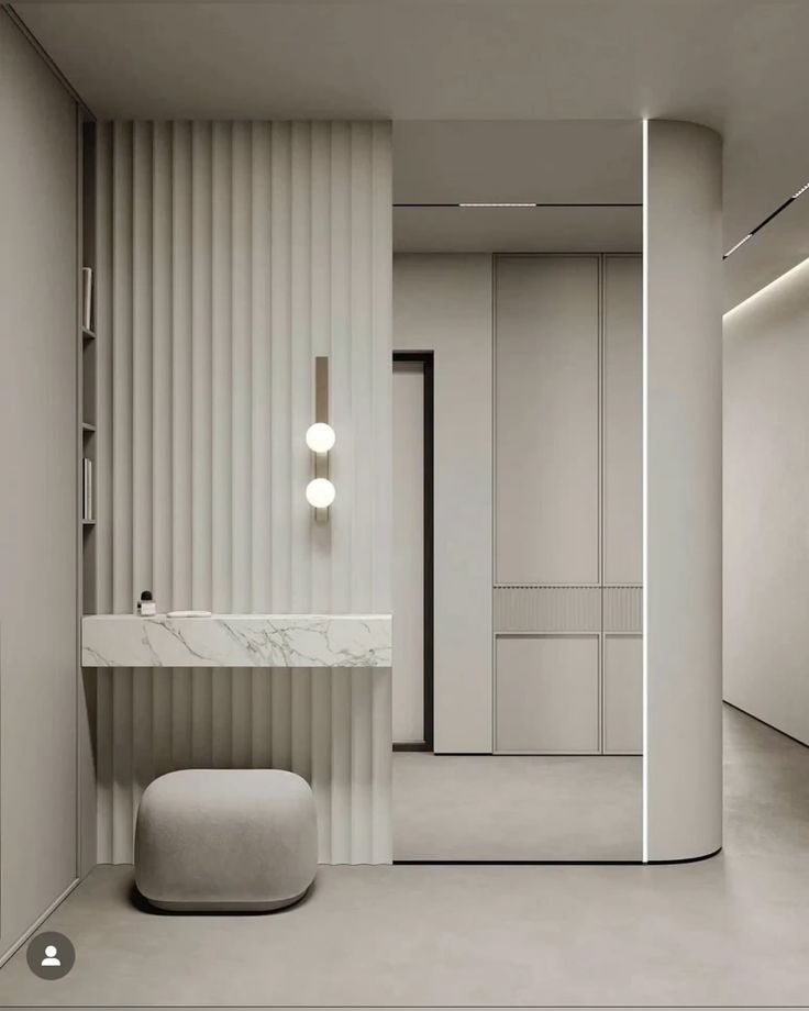 Minimalistic interior with marble sink, modern lighting, and soft neutral tones.