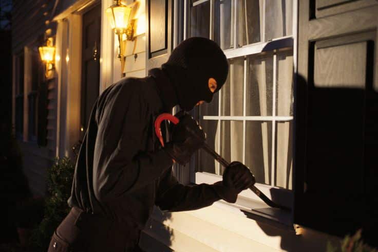 10 Ways to Break Into a House Burglar in a black mask using a crowbar to break into a house through a window at night. | Sky Rye Design Burglar in a black mask using a crowbar to break into a house through a window at night.