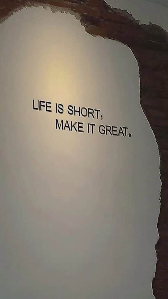 Wall art with motivational quote: Life is short, make it great. on textured background.